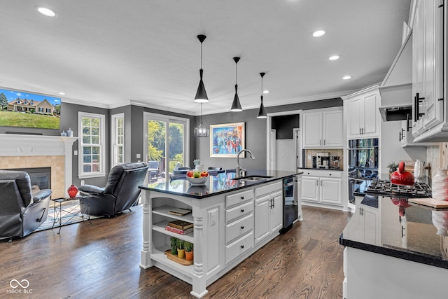 11354 Redwing Ct, Fishers, IN 46037 - kitchen featuring white cabinetry, open shelves, dark wood-type flooring, recessed lighting, and a tiled fireplace