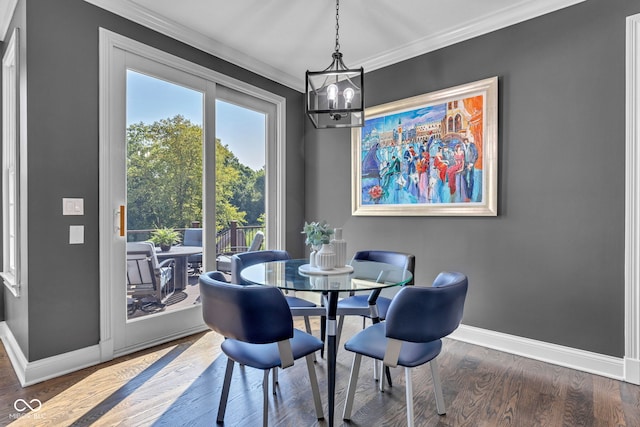 11354 Redwing Ct, Fishers, IN 46037 - dining space with crown molding, a chandelier, and wood finished floors