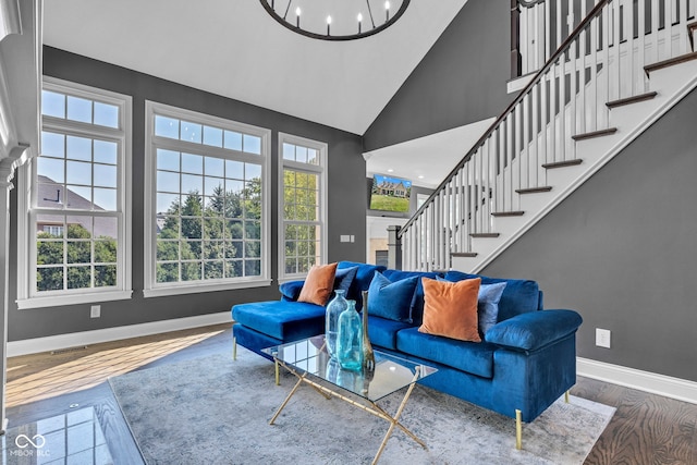 11354 Redwing Ct, Fishers, IN 46037 - living room with high vaulted ceiling, stairs, wood finished floors, and a chandelier