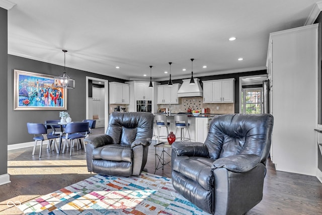 11354 Redwing Ct, Fishers, IN 46037 - living room with ornamental molding, recessed lighting, wood finished floors, and a chandelier