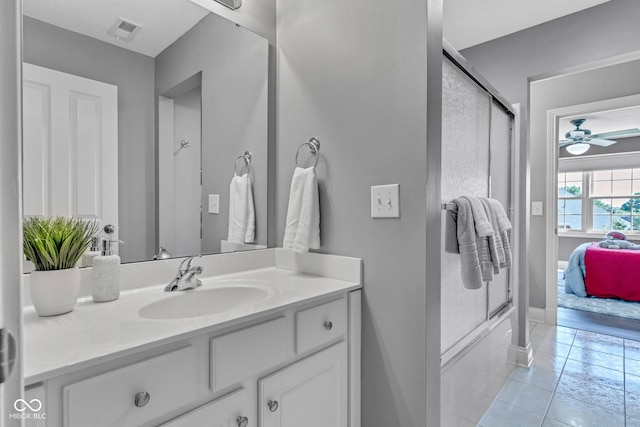 11354 Redwing Ct, Fishers, IN 46037 - bathroom featuring vanity, tile patterned flooring, connected bathroom, ceiling fan, and combined bath / shower with glass door