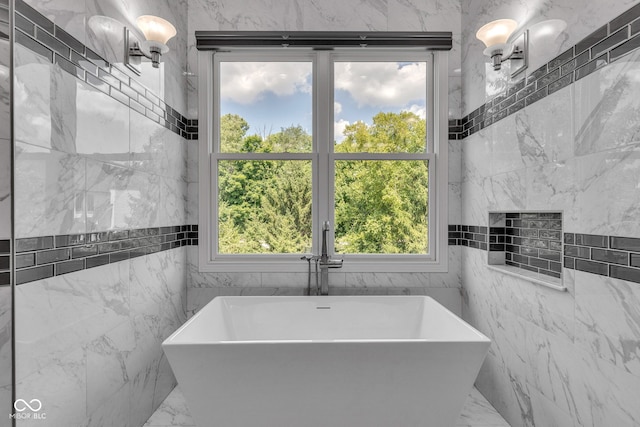 11354 Redwing Ct, Fishers, IN 46037 - bathroom featuring a soaking tub, tile walls, and marble tiled flooring