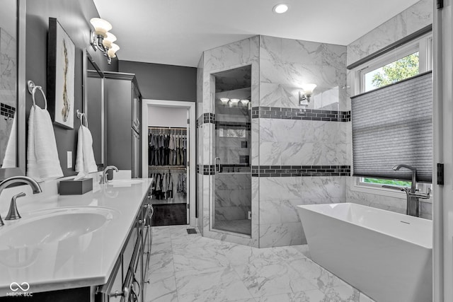 11354 Redwing Ct, Fishers, IN 46037 - bathroom with a freestanding bath, a shower stall, double vanity, marble finish floors, and a walk in closet
