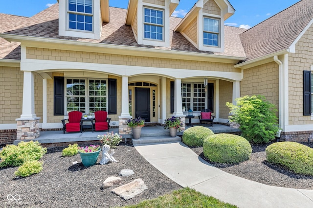 11354 Redwing Ct, Fishers, IN 46037 - view of exterior entry with covered porch and roof with shingles