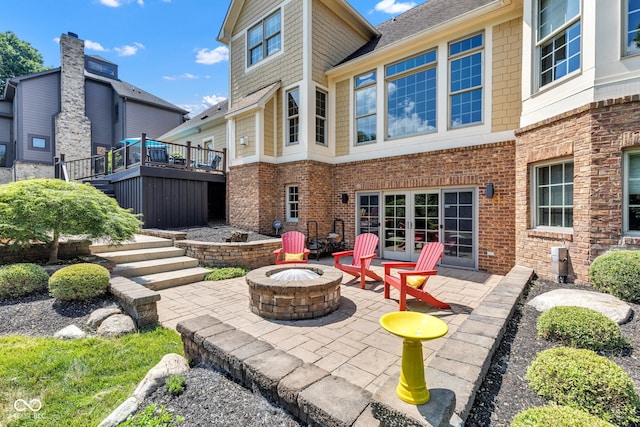 11354 Redwing Ct, Fishers, IN 46037 - view of patio / terrace featuring a fire pit, a wooden deck, stairway, and french doors