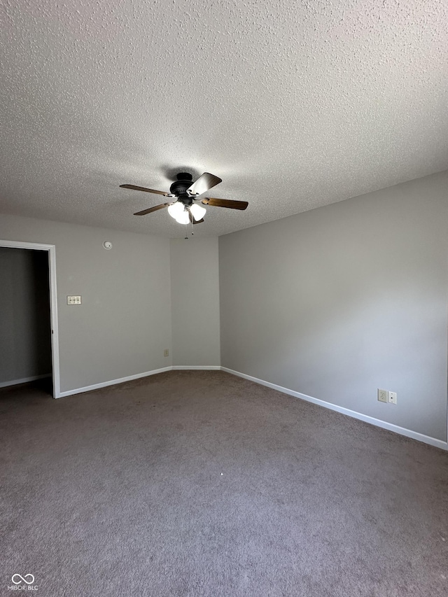 2964 Sentiment Ln, Greenwood, IN 46143 - empty room with ceiling fan, dark carpet, and a textured ceiling