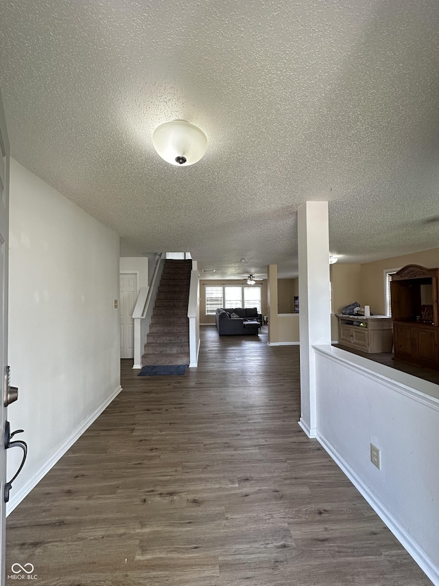 2964 Sentiment Ln, Greenwood, IN 46143 - corridor featuring a textured ceiling, stairs, and wood finished floors