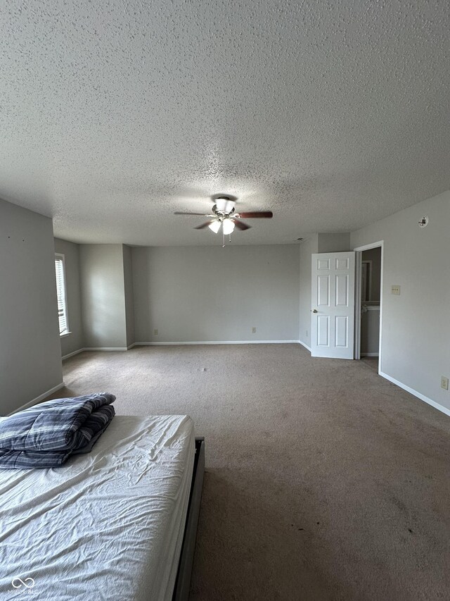 2964 Sentiment Ln, Greenwood, IN 46143 - unfurnished bedroom with carpet flooring, a textured ceiling, and ceiling fan