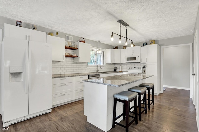 3280 E 300 S, Greenfield, IN 46140 - kitchen featuring white appliances, open shelves, a breakfast bar, decorative backsplash, and a textured ceiling