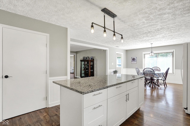 3280 E 300 S, Greenfield, IN 46140 - kitchen featuring dark wood-style floors, a textured ceiling, white cabinets, dark stone counters, and a center island