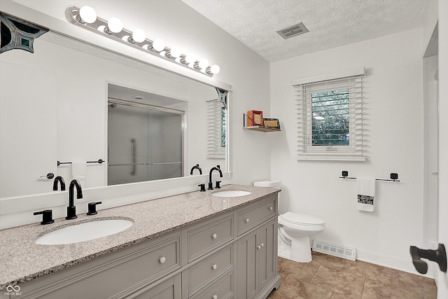 3280 E 300 S, Greenfield, IN 46140 - bathroom featuring double vanity, a shower with shower door, and a textured ceiling