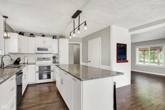 3280 E 300 S, Greenfield, IN 46140 - kitchen featuring white appliances, dark wood finished floors, tasteful backsplash, dark stone countertops, and white cabinets