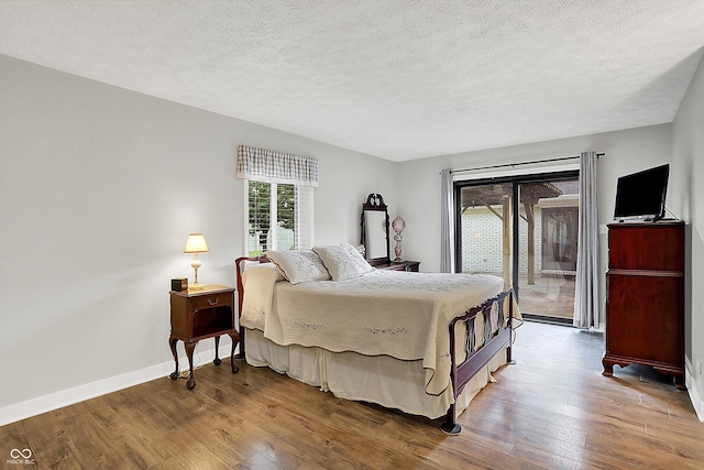 3280 E 300 S, Greenfield, IN 46140 - bedroom featuring access to exterior, wood-type flooring, and a textured ceiling