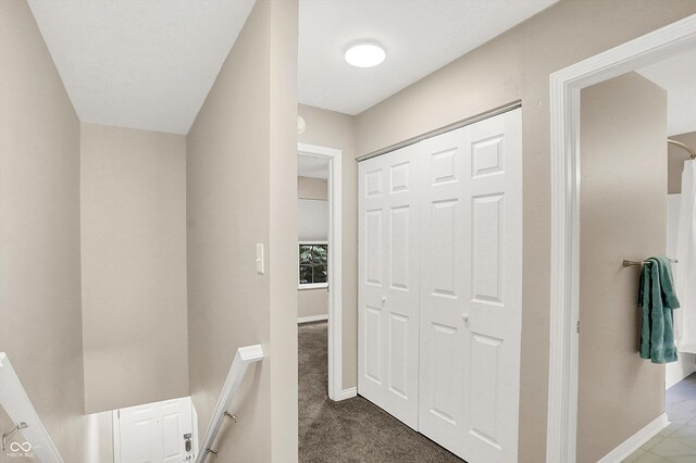 3084 Armory Dr, Indianapolis, IN 46208 - hallway with dark carpet and an upstairs landing
