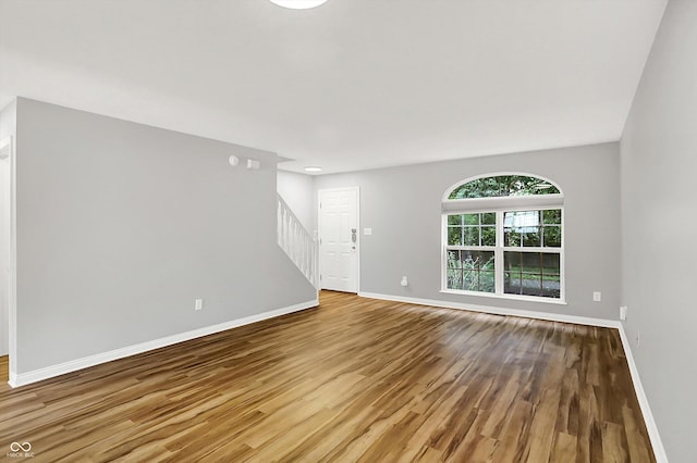 3084 Armory Dr, Indianapolis, IN 46208 - unfurnished living room featuring wood finished floors and stairs