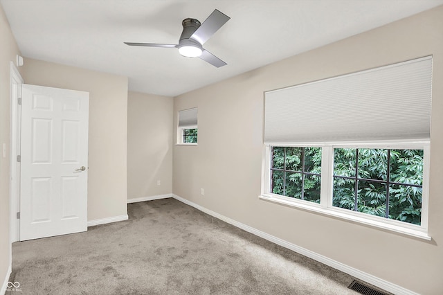 3084 Armory Dr, Indianapolis, IN 46208 - unfurnished bedroom featuring carpet floors, multiple windows, and a ceiling fan