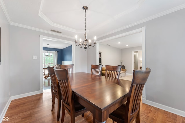 7045 W 100 N, Greenfield, IN 46140 - dining area with a chandelier, light wood-type flooring, ornamental molding, and a raised ceiling