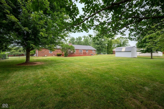 7045 W 100 N, Greenfield, IN 46140 - view of grassy yard with an outdoor structure and a wooden deck