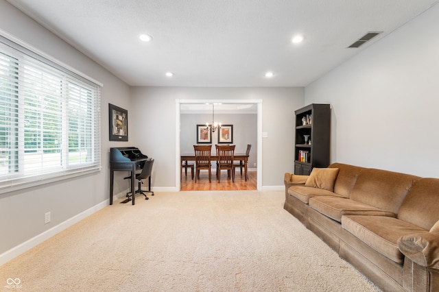 7045 W 100 N, Greenfield, IN 46140 - living room with light colored carpet, a chandelier, recessed lighting, and a desk