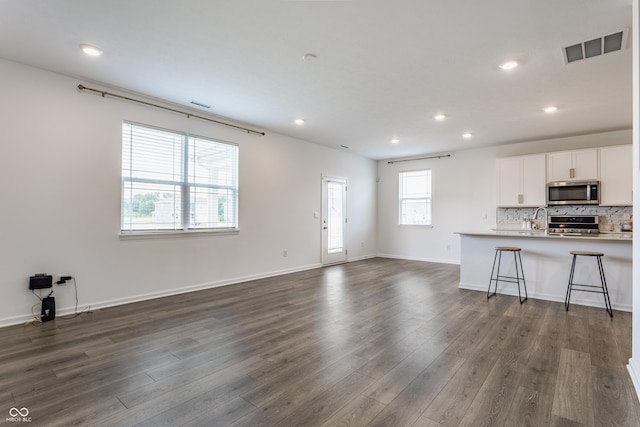6143 Madera Dr, Whitestown, IN 46075 - unfurnished living room with recessed lighting and dark wood-style flooring