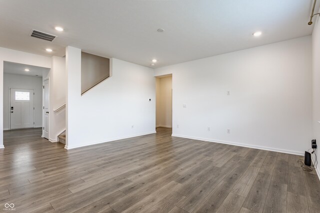 6143 Madera Dr, Whitestown, IN 46075 - empty room featuring wood finished floors, stairs, and recessed lighting
