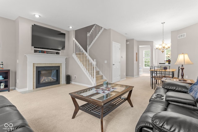 866 Rosalind Pl, Carmel, IN 46032 - living room featuring light carpet, a chandelier, a tiled fireplace, and stairs