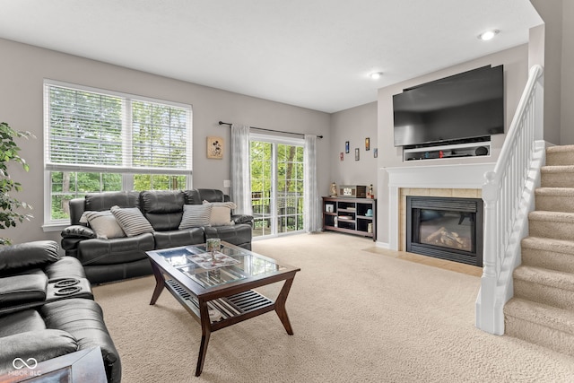 866 Rosalind Pl, Carmel, IN 46032 - living room featuring a tile fireplace, stairway, and carpet