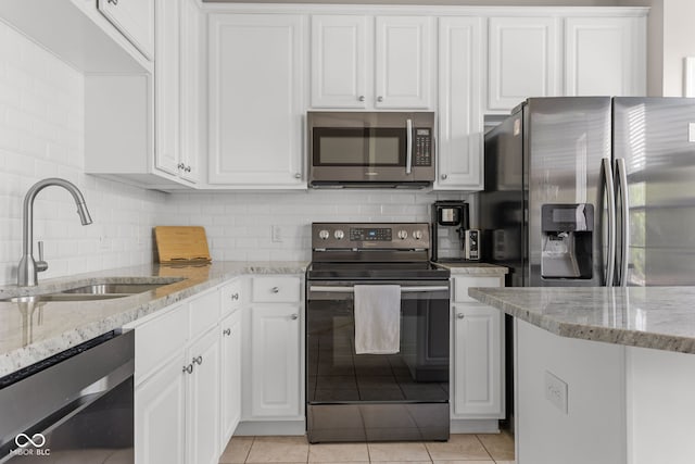 866 Rosalind Pl, Carmel, IN 46032 - kitchen with appliances with stainless steel finishes, white cabinetry, and light tile patterned flooring