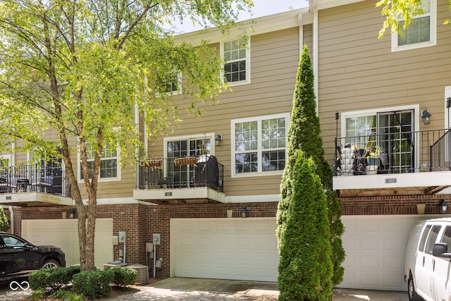 866 Rosalind Pl, Carmel, IN 46032 - back of house with an attached garage, brick siding, and concrete driveway