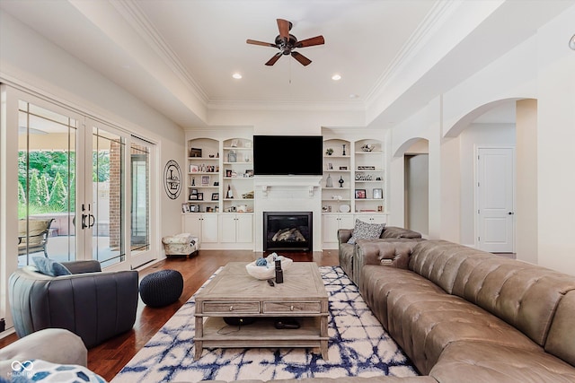 4545 Pascagoula Run, Greenwood, IN 46143 - living area featuring arched walkways, ornamental molding, a ceiling fan, wood finished floors, and a raised ceiling
