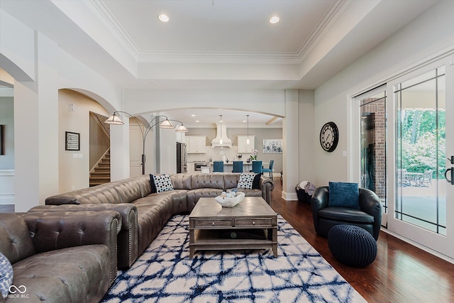 4545 Pascagoula Run, Greenwood, IN 46143 - living room featuring arched walkways, wood finished floors, a raised ceiling, plenty of natural light, and recessed lighting