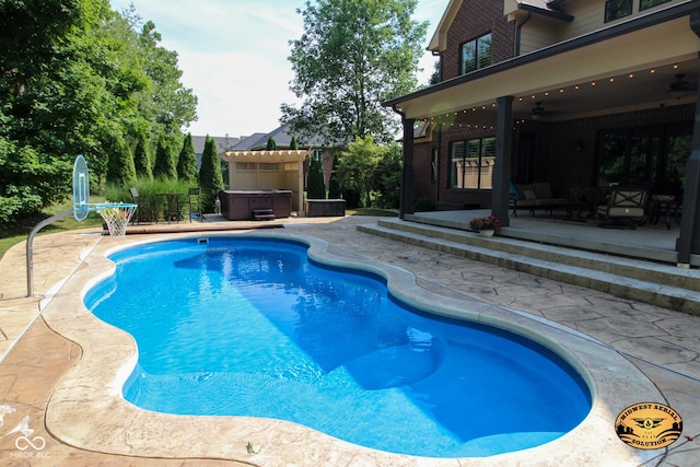 4545 Pascagoula Run, Greenwood, IN 46143 - view of swimming pool with a hot tub, a patio, and a ceiling fan