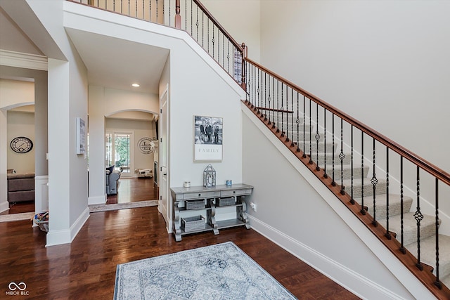 4545 Pascagoula Run, Greenwood, IN 46143 - stairs with arched walkways, wood finished floors, a towering ceiling, and recessed lighting
