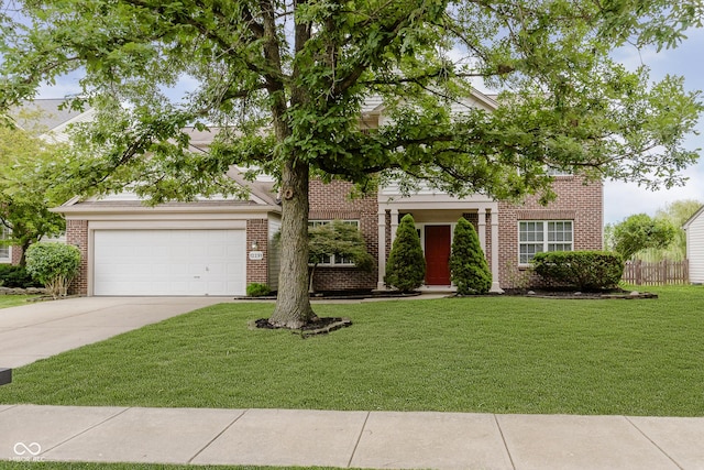 12291 Cobblestone Dr, Fishers, IN 46037 - view of property hidden behind natural elements featuring brick siding, concrete driveway, a front lawn, and an attached garage