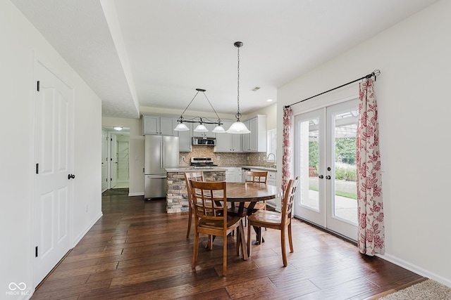 12291 Cobblestone Dr, Fishers, IN 46037 - dining area with french doors and dark wood-style flooring