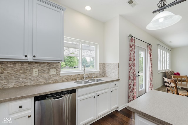 12291 Cobblestone Dr, Fishers, IN 46037 - kitchen with dishwasher, dark wood-style flooring, decorative backsplash, pendant lighting, and light countertops