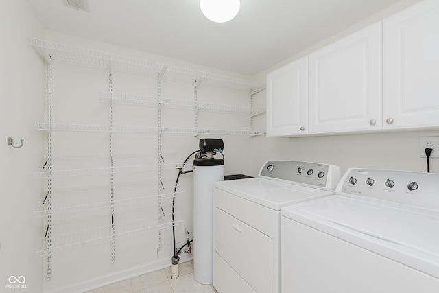 12291 Cobblestone Dr, Fishers, IN 46037 - laundry area with cabinet space, washing machine and dryer, and light tile patterned flooring