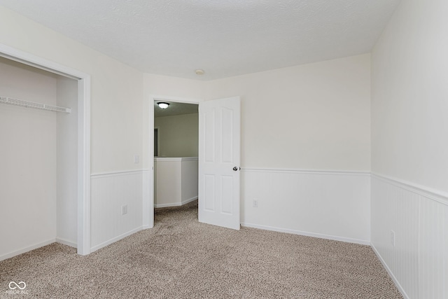 12291 Cobblestone Dr, Fishers, IN 46037 - unfurnished bedroom featuring carpet, wainscoting, and a closet