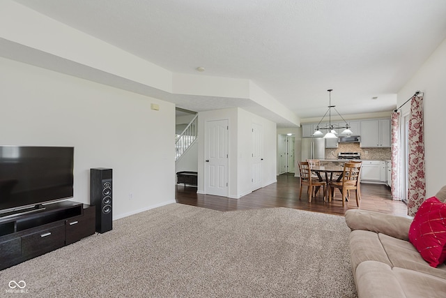 12291 Cobblestone Dr, Fishers, IN 46037 - living area featuring dark carpet and stairs