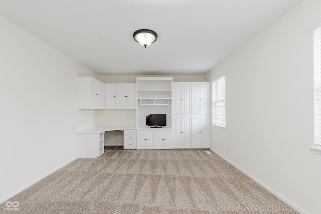 12291 Cobblestone Dr, Fishers, IN 46037 - unfurnished living room featuring built in study area and light carpet