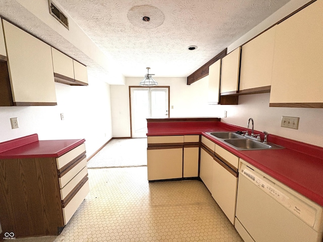 6458 Watham Ct, Indianapolis, IN 46250 - kitchen with white dishwasher, a textured ceiling, a peninsula, cream cabinets, and dark countertops