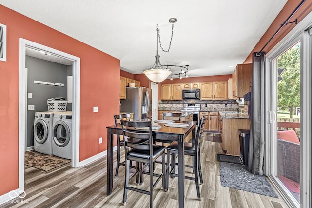 12034 Gatwick View Dr, Fishers, IN 46037 - dining area featuring washing machine and dryer and wood finished floors