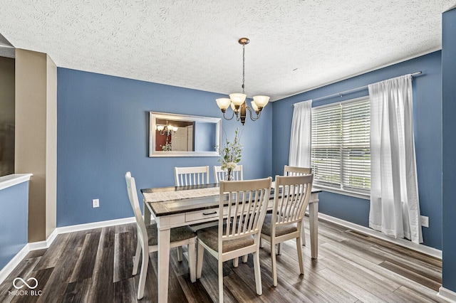 12034 Gatwick View Dr, Fishers, IN 46037 - dining space featuring a chandelier, wood finished floors, and a textured ceiling