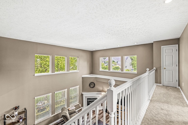 12034 Gatwick View Dr, Fishers, IN 46037 - hallway with a textured ceiling, recessed lighting, carpet floors, and an upstairs landing