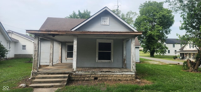 308 E Washington St, Saint Paul, IN 47272 - shotgun-style home with a porch and a front lawn