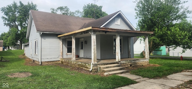 308 E Washington St, Saint Paul, IN 47272 - view of front of property featuring a porch, a front yard, and a shingled roof