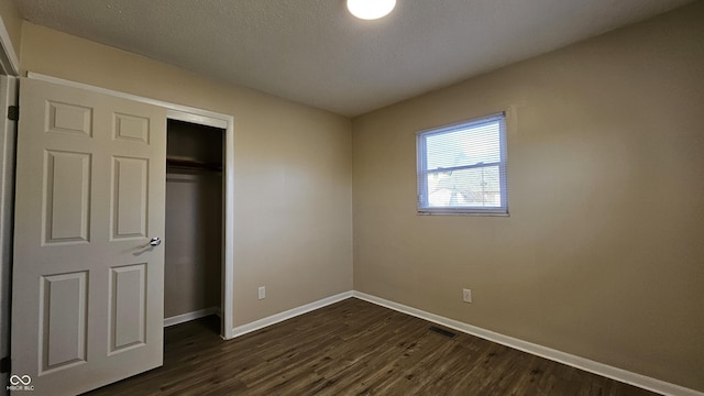 4107 Weaver Ave, Indianapolis, IN 46227 - unfurnished bedroom featuring dark wood-style floors and a closet