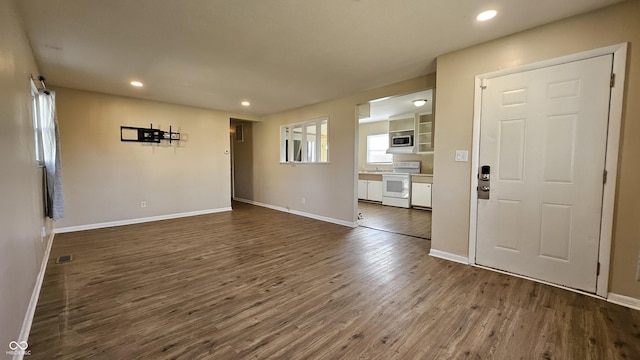 4107 Weaver Ave, Indianapolis, IN 46227 - unfurnished living room featuring dark wood-style floors and recessed lighting