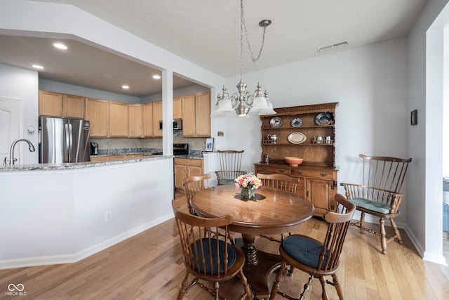 12985 Merlot Ln, Fishers, IN 46037 - dining room featuring light wood-style flooring, recessed lighting, and a chandelier