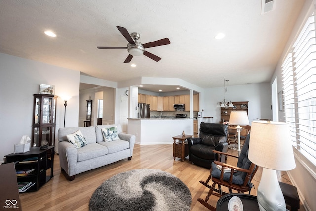 12985 Merlot Ln, Fishers, IN 46037 - living room featuring a ceiling fan, light wood finished floors, healthy amount of natural light, and recessed lighting